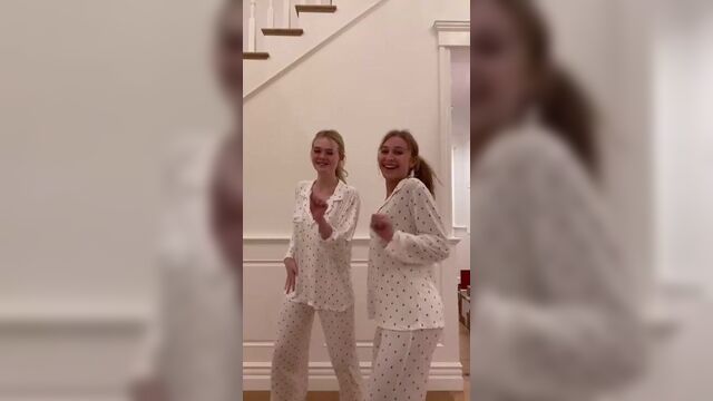 Elle Fanning and a blonde friend dancing in their pajamas