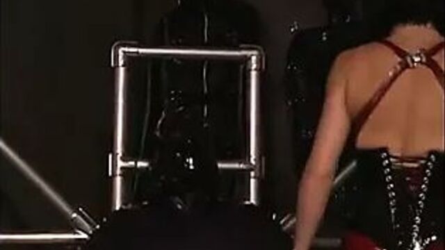 Lesbians perform hardcore S&M with masks and latex