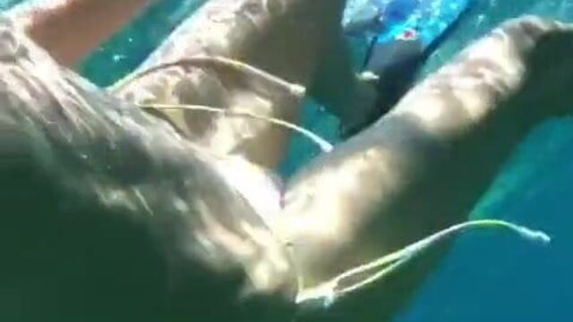 Heidi Klum swimming underwater in a bikini